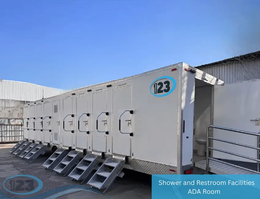 Long mobile shower and restroom trailer with multiple private stall doors, entry steps, and ADA-accessible ramp